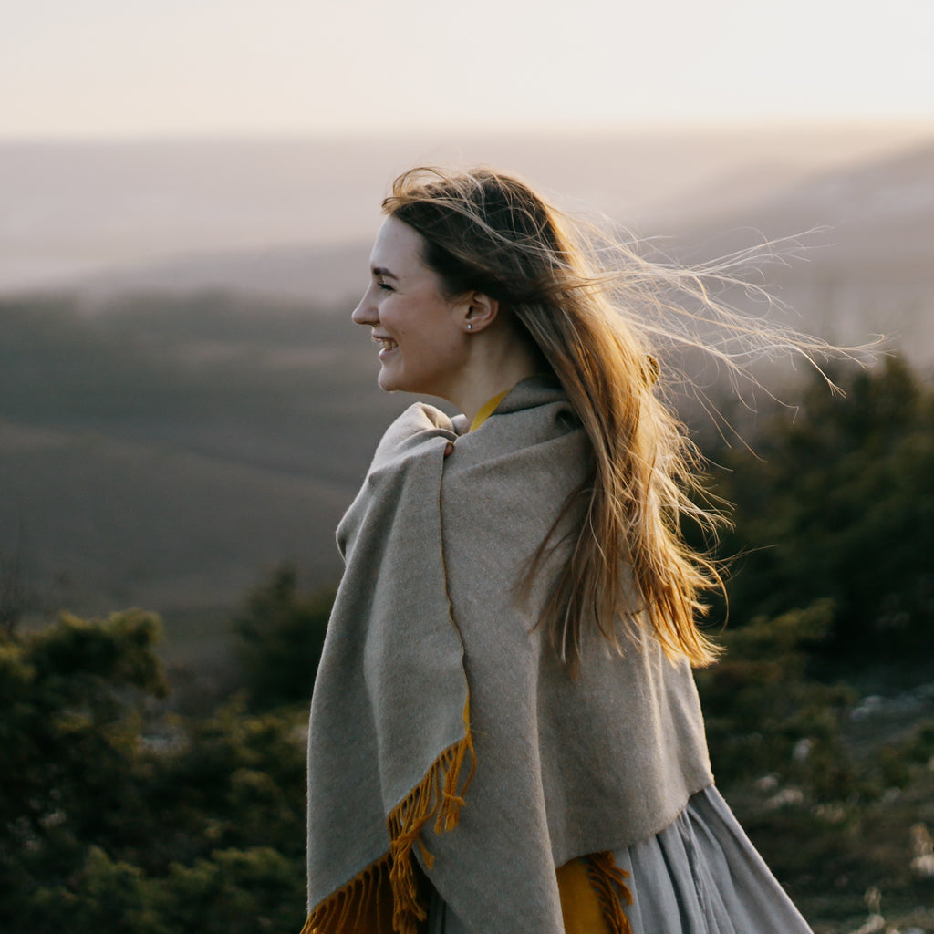 Sleep Consultant in Ireland looking out over the mountains with blanket around her